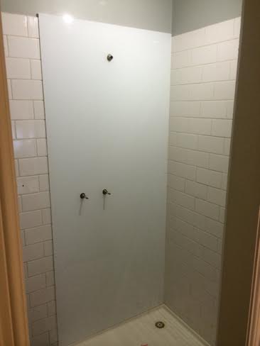 White acrylic splashbacks installed directly over tiled walls